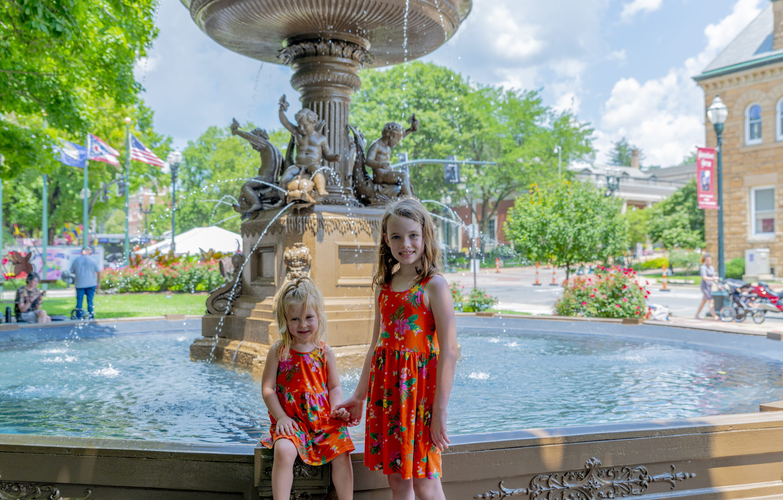 kids posing for a picture beside the fountain