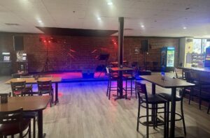 interior of a sandwich shop restaurant with neon lights and large stage