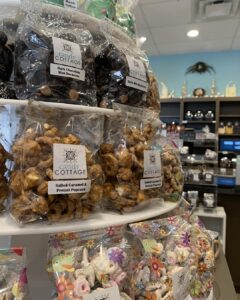 candy on display including salted caramel & pretzel popcorn, dark chocolate mini buckeyes and other candy in a candy shop