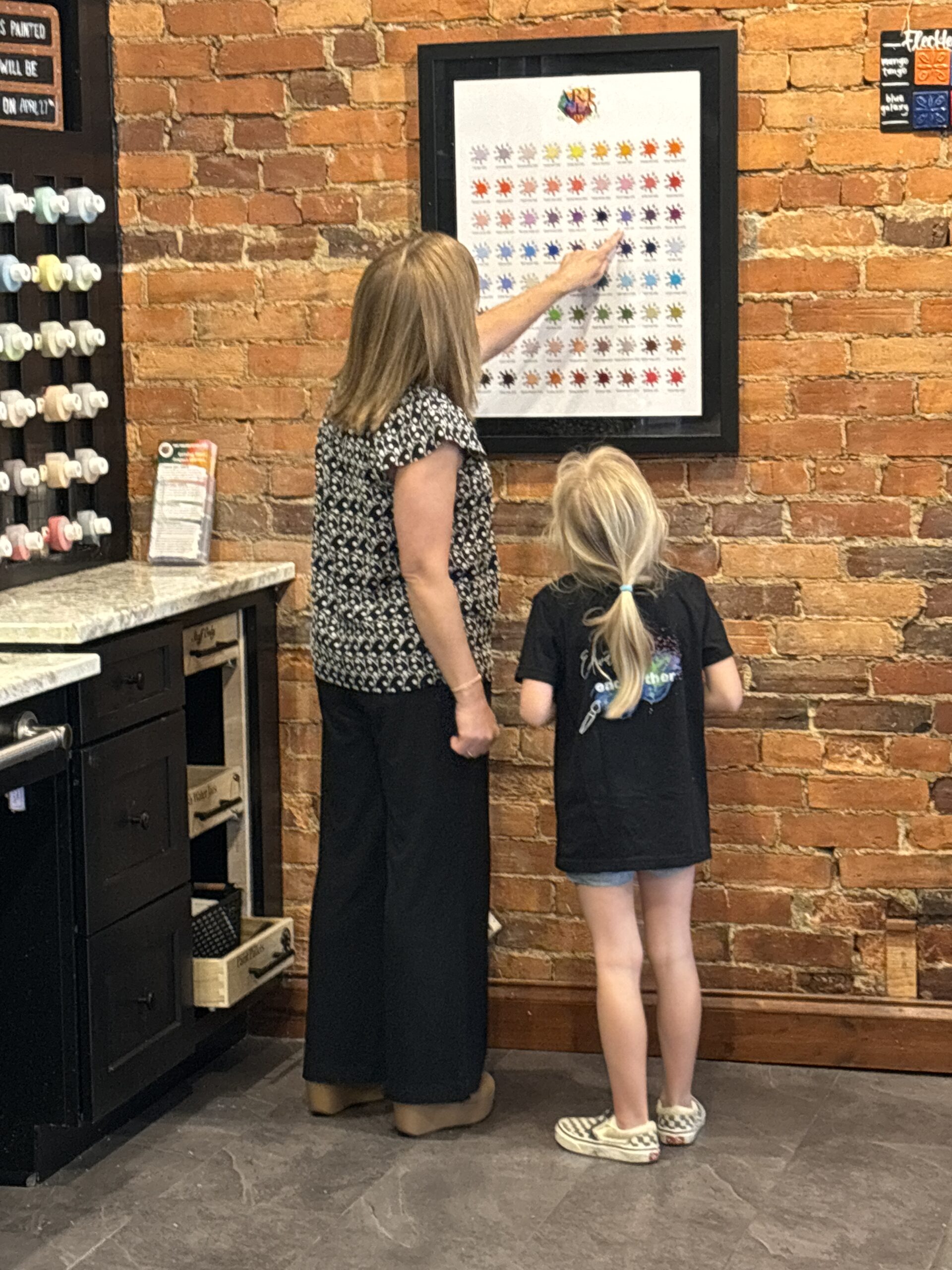 people looking at different colors of paint at Art and Clay in downtown Lancaster Ohio