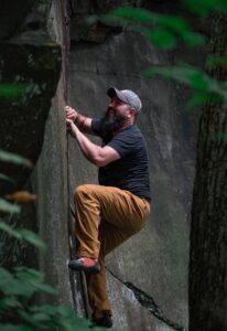 man climbing rocks