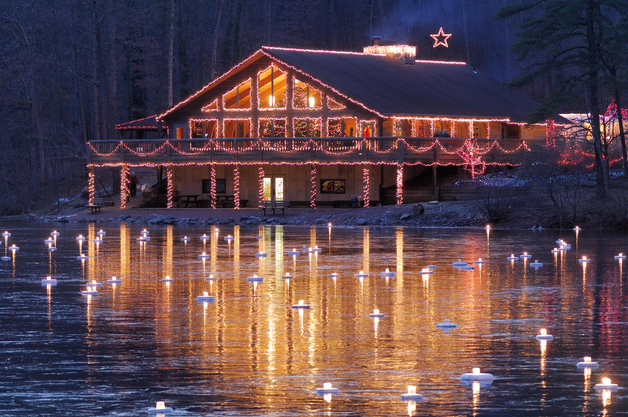 Lights on the frozen surface of Lake Loretta near the Nature Center during Santa and Friends at Alley Park in Lancaster, Ohio.