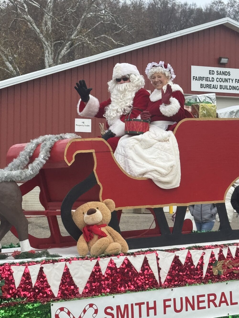 santa and Mrs. Claus on a holiday float in a christmas parade