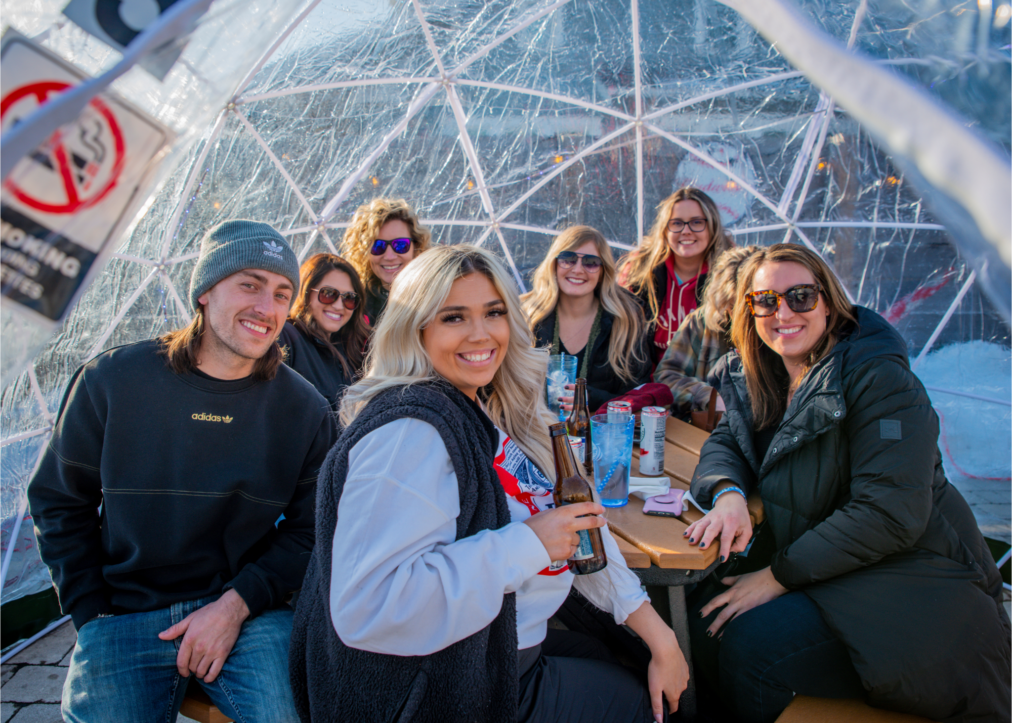 people in an igloo drinking beer