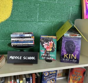 books displayed on top of a bookshelf