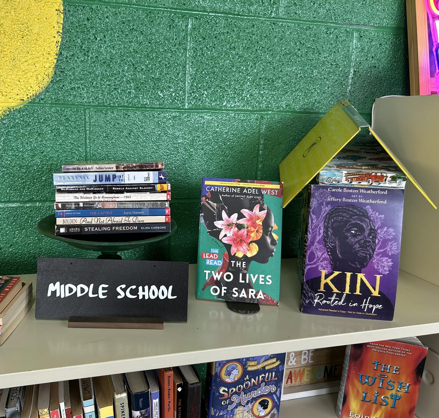 books displayed on top of a bookshelf