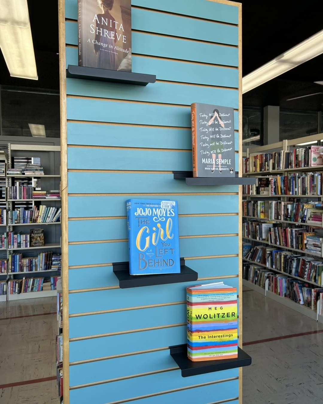 books being displayed on a side wall of a bookshelp