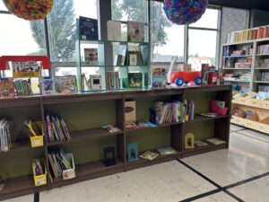 books and other items being displayed on a short bookshelf