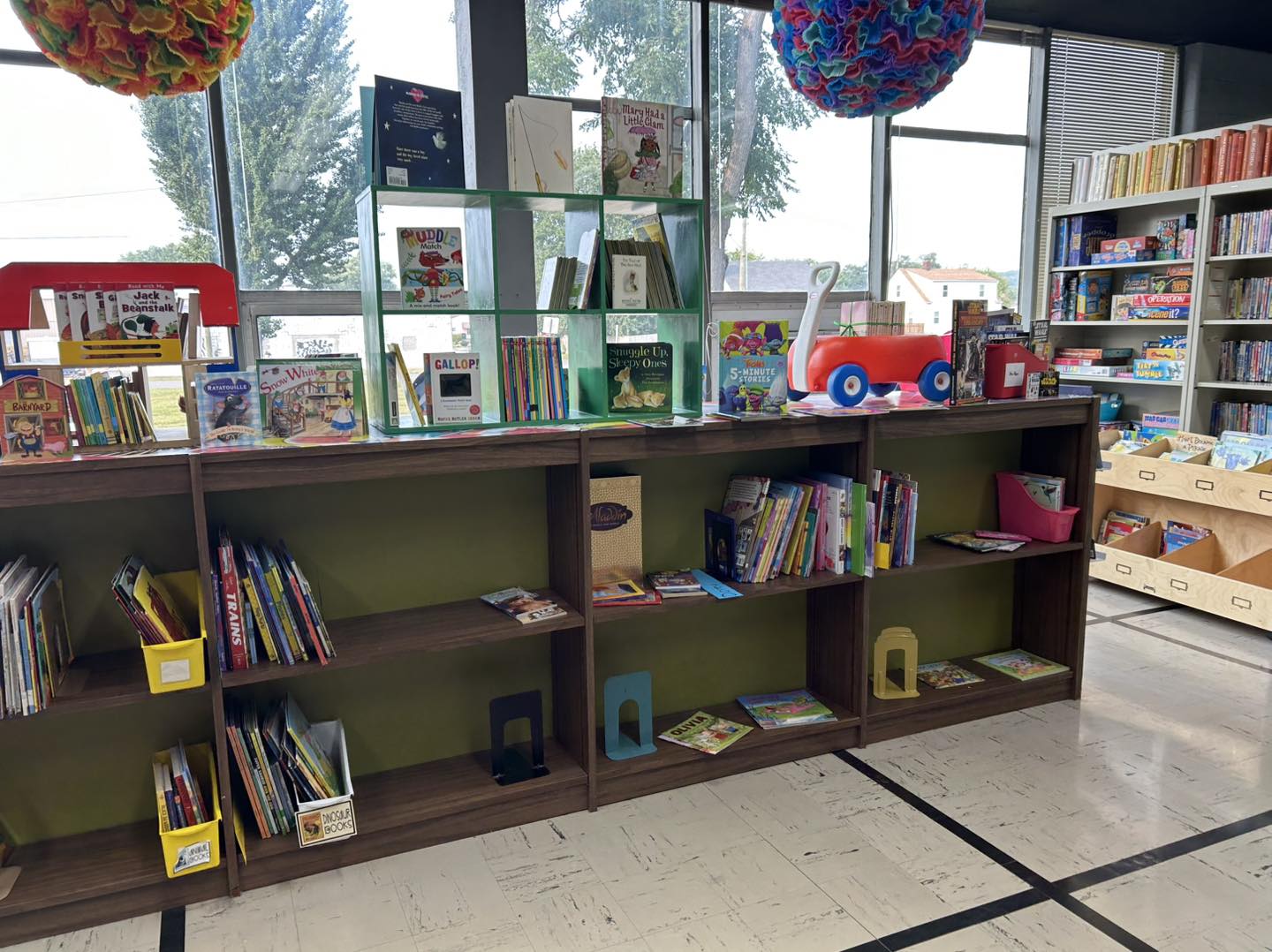 books and other items being displayed on a short bookshelf