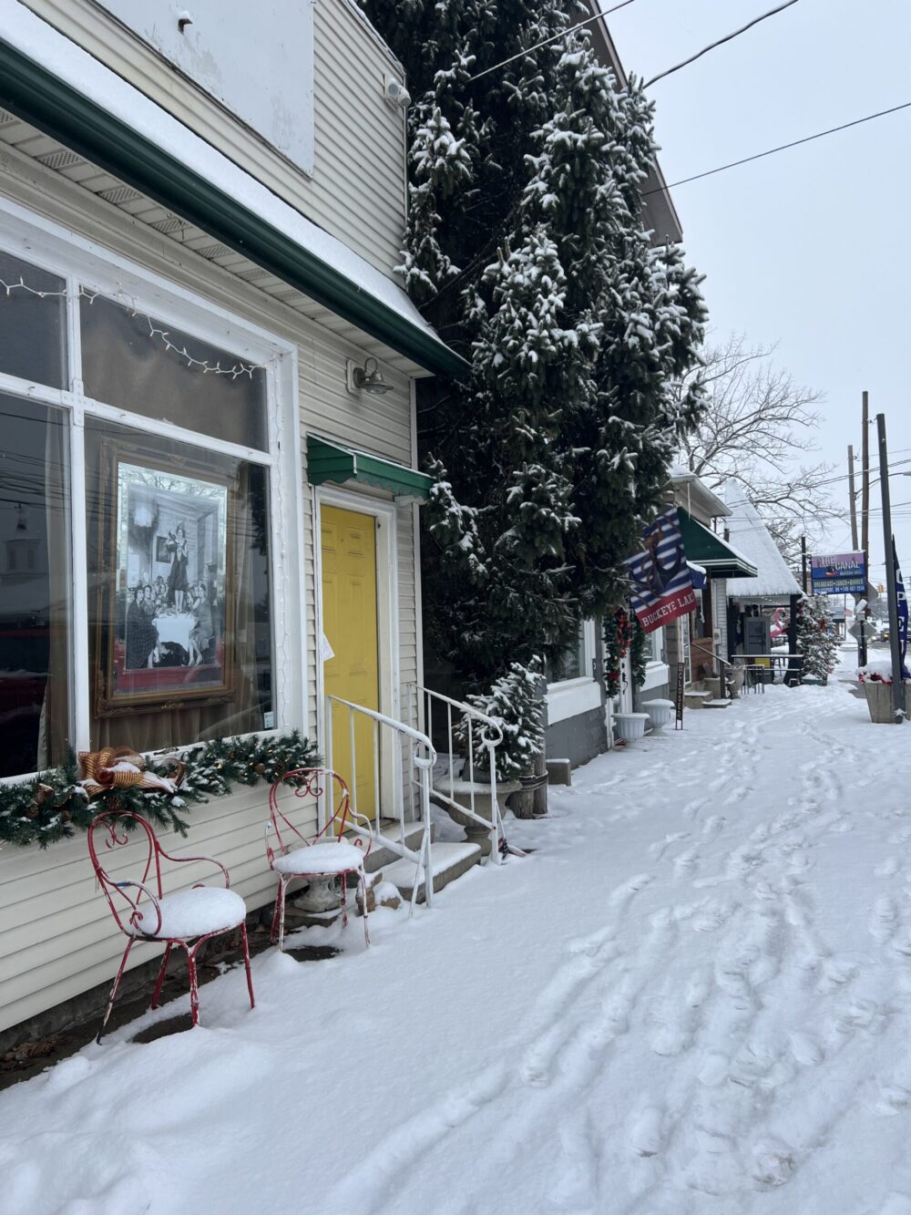 village of millersport in the winter with the sidewalk covered in show