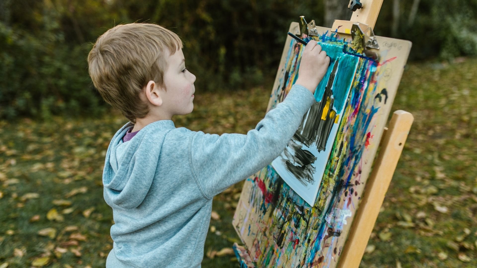 A child painting on a canvas