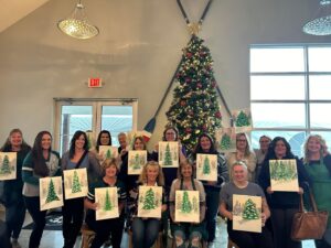 christmas tree paintings being displayed by different artists in a group at Buckeye lake Winery