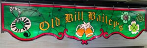 Photo of a stained glass sign at Old Bill Baileys bar