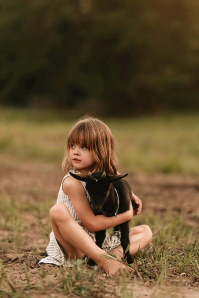 Photo of a child with a goat at Buckeye Ridge Rescue & Retreat